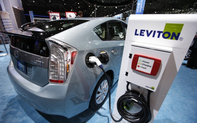 2013 Toyota Prius plug-in Hybrid car is seen plugged into Leviton charging station at Toyota display during a media preview at 2013 New York International Auto Show in New York