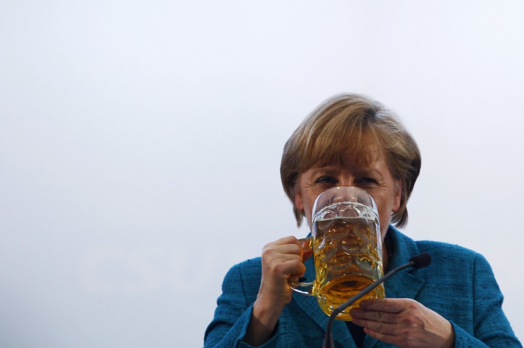 German Chancellor and head of the CDU Merkel drinks a beer after her speech in a beer tent in Munich
