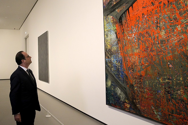French President Francois Hollande, looks at "Gudrun", an oil on canvas by Gerhard Richter during the inauguration of  the Louis Vuitton Foundation art museum during its inauguration in the Bois de Boulogne