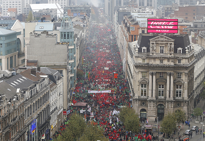 Protesters carry placards as they march through central Brussels