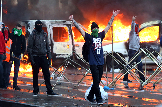 Demonstrators confront riot police during clashes in central Brussels