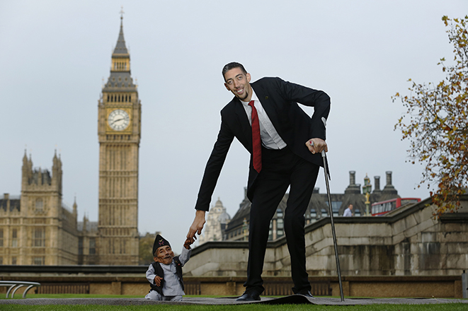 The world's shortest man Chandra Bahadur Dangi greets the tallest living man Sultan Kosen to mark the Guinness World Record's Day in London
