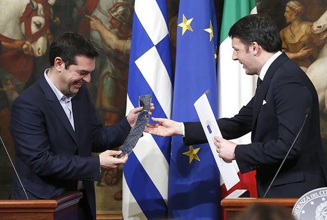 Italian Prime Minister Renzi gives a tie as a present to his Greek counterpart Tsipras during a news conference at Chigi palace in Rome