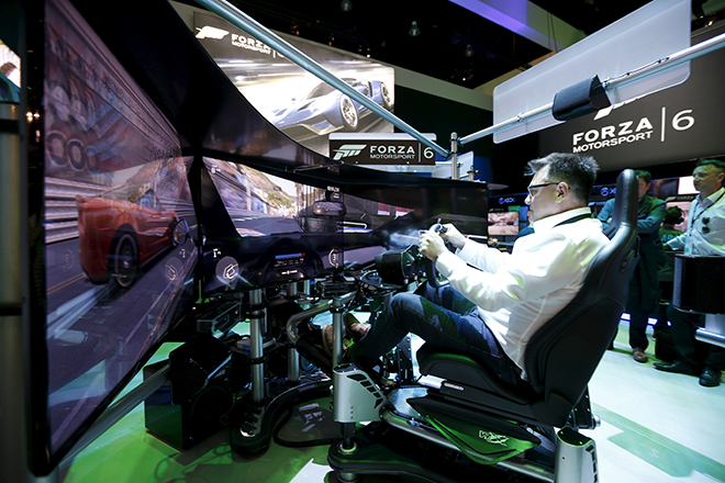 A man plays the "Forza Motorsport 6" video game simulator at the Microsoft Xbox booth at the Electronic Entertainment Expo, or E3, in Los Angeles, California, United States, June 16, 2015. REUTERS/Lucy Nicholson  - RTX1GTAT