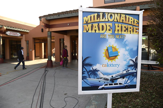 epa03995380 A sign put out in front of Jenny's Gift Shop by the California Lottery officials,  where one of the two winning Mega Millions jackpot lottery tickets was sold in San Jose, California, USA, 18 December 2013. The winners will split the estimated 636 million US dollar jackpot with the winner in Georgia. The California winner has yet to come forward with the winning ticket.  EPA/JOHN G. MABANGLO