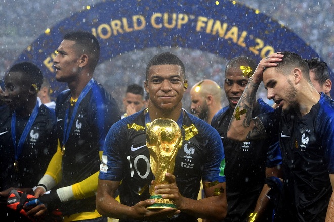 epaselect epa06891526 Kylian Mbappe of France reacts with the trophy after winning the FIFA World Cup 2018 final between France and Croatia in Moscow, Russia, 15 July 2018.
(RESTRICTIONS APPLY: Editorial Use Only, not used in association with any commercial entity - Images must not be used in any form of alert service or push service of any kind including via mobile alert services, downloads to mobile devices or MMS messaging - Images must appear as still images and must not emulate match action video footage - No alteration is made to, and no text or image is superimposed over, any published image which: (a) intentionally obscures or removes a sponsor identification image; or (b) adds or overlays the commercial identification of any third party which is not officially associated with the FIFA World Cup) EPA/FACUNDO ARRIZABALAGA EDITORIAL USE ONLY