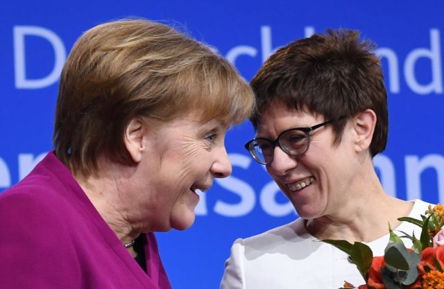 epa06566741 German Chancellor Angela Merkel (L) and Annegret Kramp-Karrenbauer (R), the newly elected CDU General Secretary, react during the 30th party convention of Christian Democratic Union (CDU) in Berlin, Germany, 26 February 2018. The party delegates vote on the entry of the CDU into a government coalition with the Social Democratic Party (SPD) and the Christian Social Union (CSU). On the previous day, the Chancellor presented her list of candidates for the CDU cabinet members. Kramp-Karrenbauer was elected with 98.87 percent of the delegates' votes.  EPA/CLEMENS BILAN