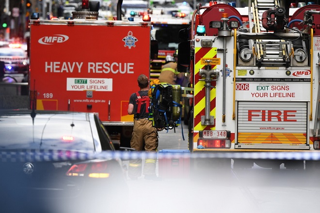 epa07152634 Emergency workers are seen on Bourke street in Melbourne, Australia, 09 November 2018. According to early media reports, an unidentified man set a vehicle alight and stabbed two people before being shot by police in the Central Business District of Melbourne. At least one person was killed during the incident. The perpetrator was taken into custody and is reportedly in critical condition.  EPA/JAMES ROSS AUSTRALIA AND NEW ZEALAND OUT