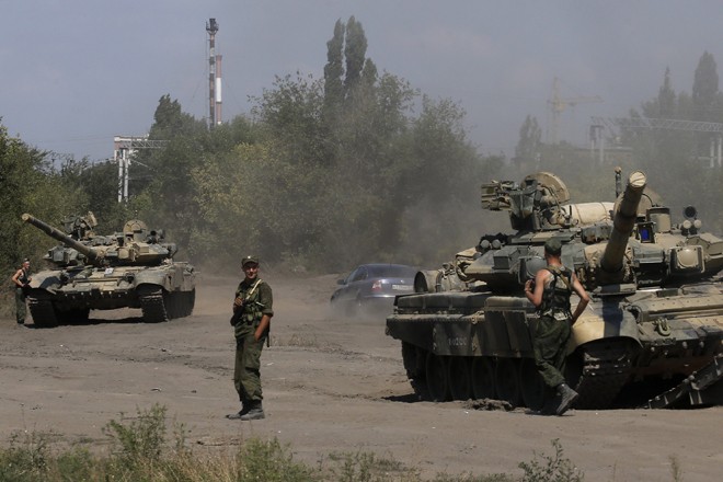 Russian soldiers are pictured next to tanks in Kamensk-Shakhtinsky, Rostov region, near the border with Ukraine