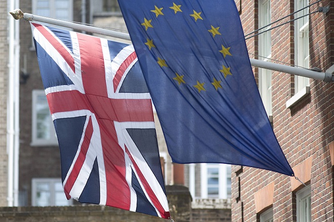 The Union Flag flies next to the European Flag outside the European Commission building in central London